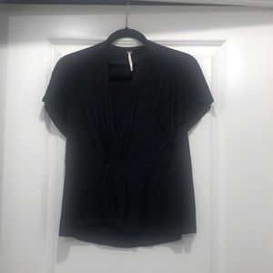 Free People stylish tee - twist at center with cut out around chest area - black